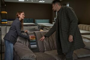 Young couple examining fabric samples in furniture store